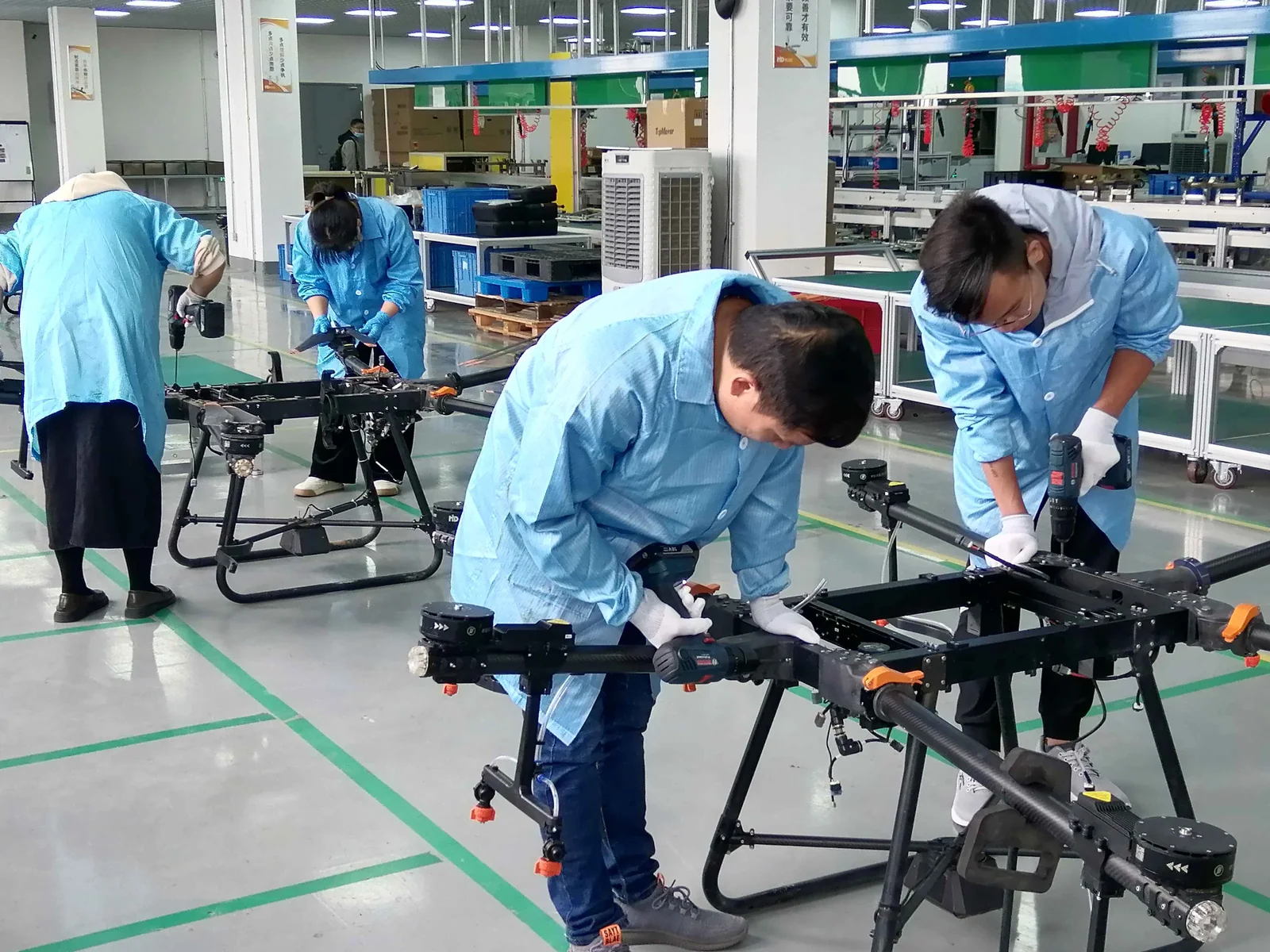 Technicians fitting the airframe of an agricultural drone during an OEM production run