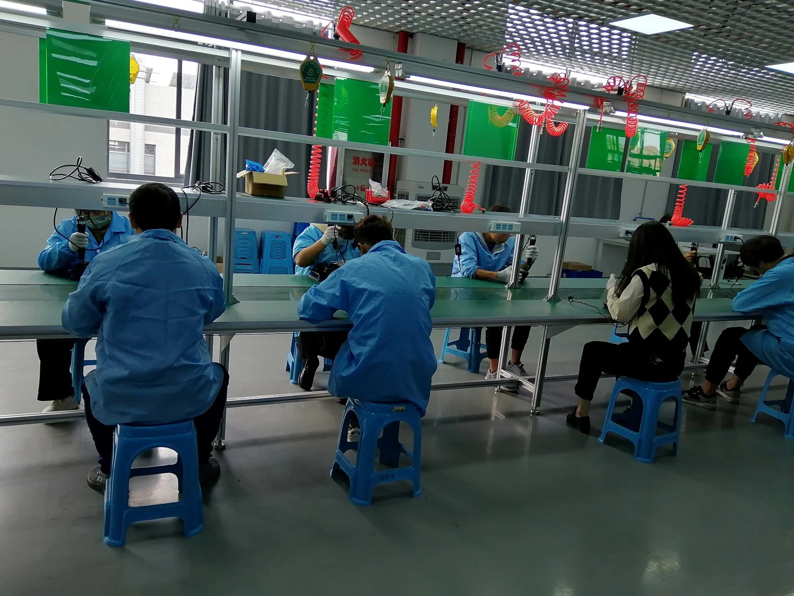 Operators assembling spray-system components on the Jitian Intelligent production line