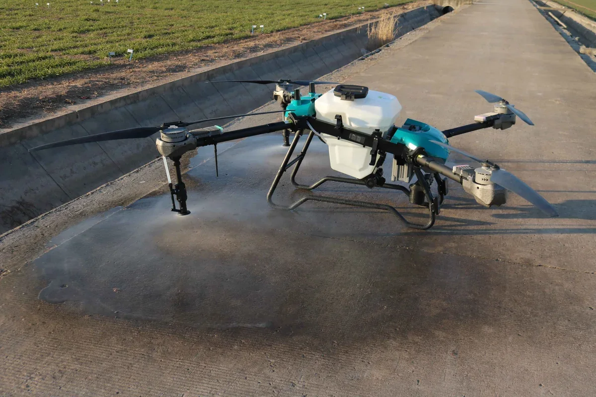 JT-80 agricultural drone spraying over a field during a demonstration